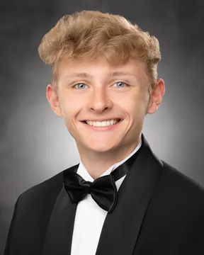 Blonde senior portrait illustrating eye alignment and clearance above the hair